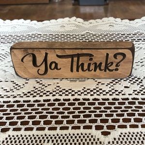 Sarcastic wooden sign “YA THINK”